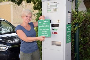 © Stadtgemeinde Mödling/ Nina Mrazek präsentiert den Info-Aufkleber, der auf die Parkschein-Automaten angebracht wird
